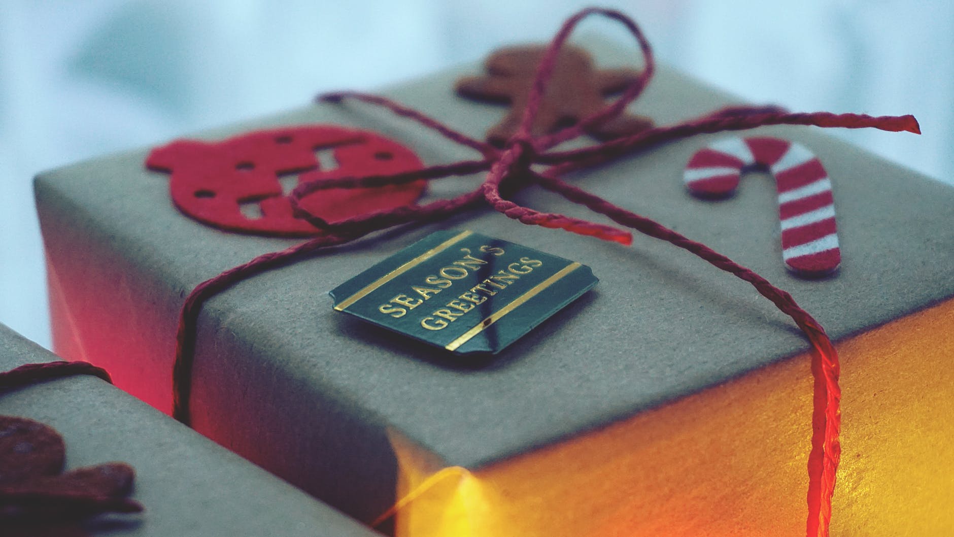 close up photo of a gift box wrapped with red string