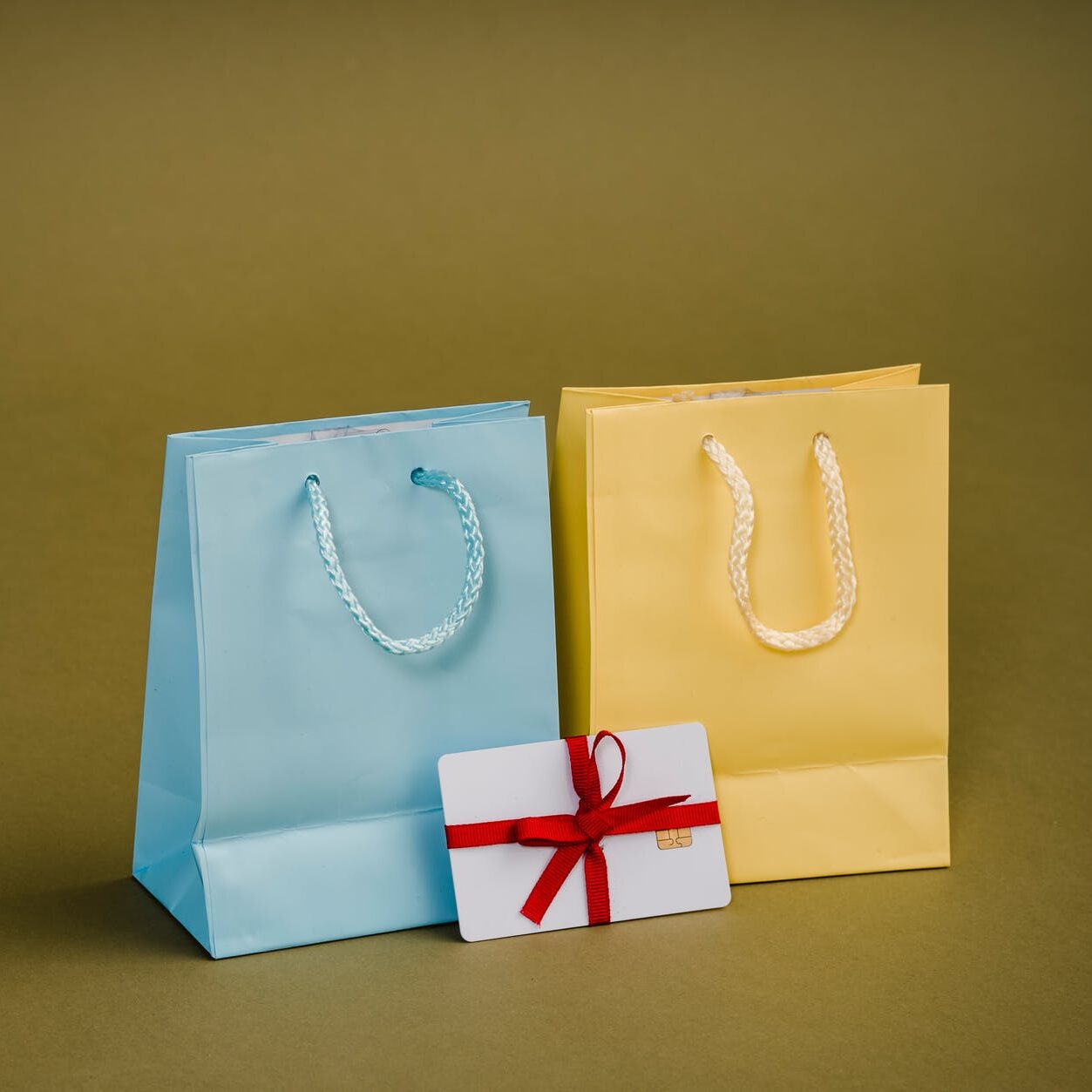 assorted gift bags with cords on brown background