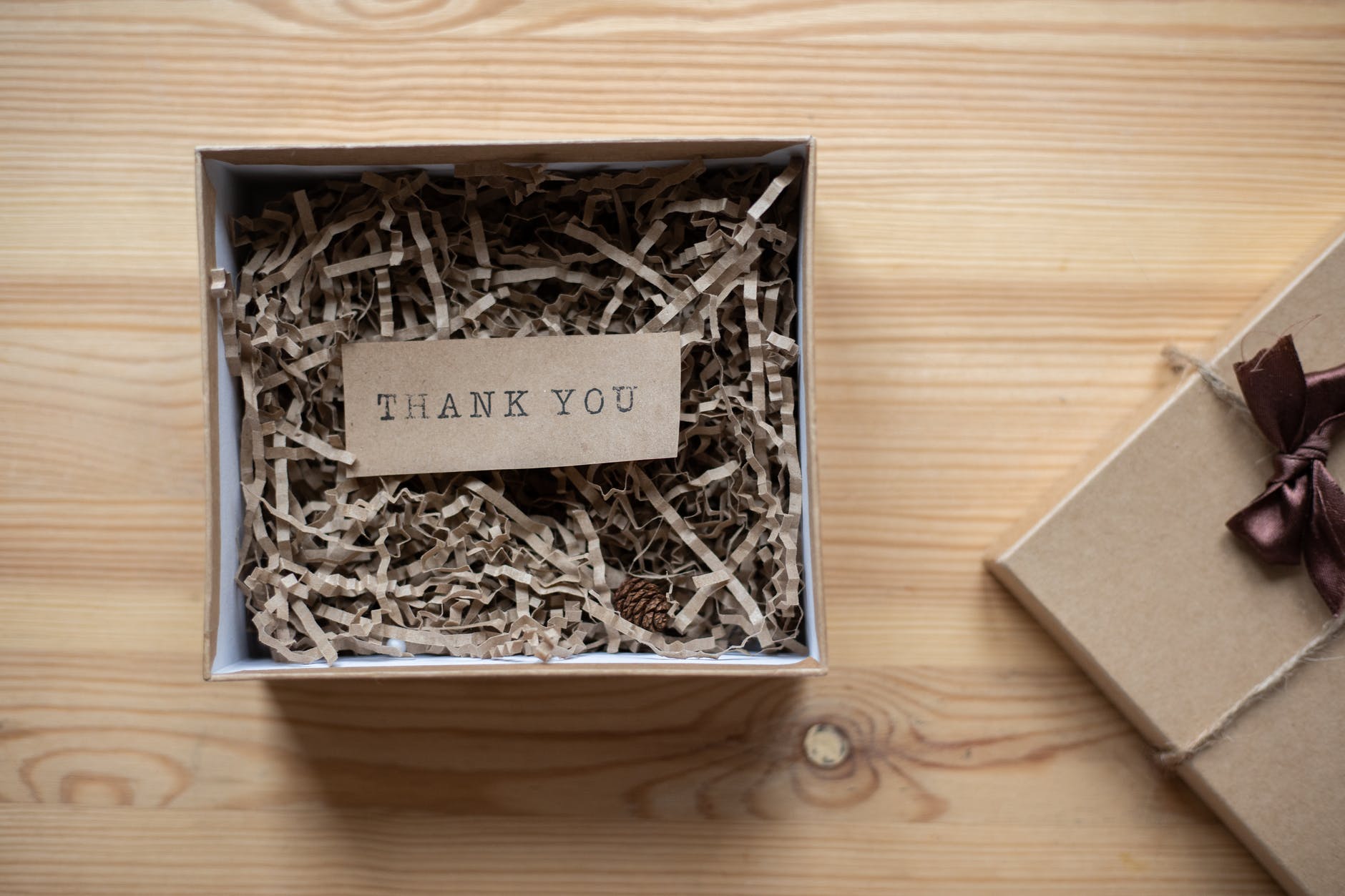 cardboard gift box with postcard on table