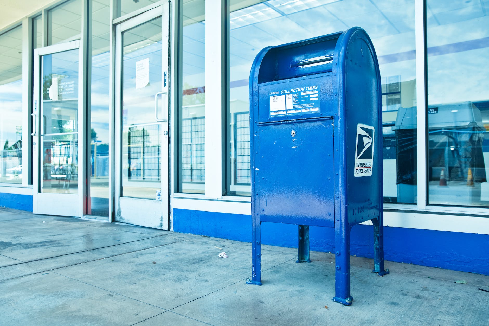 blue mailbox outside a building