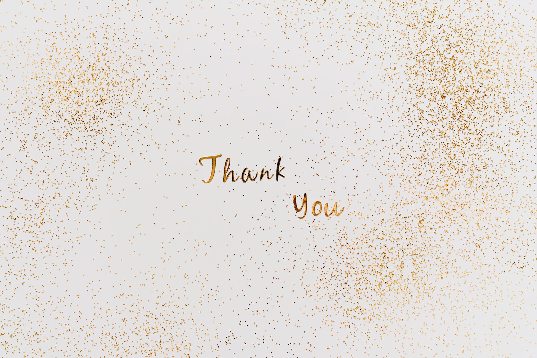 gold thank you text with gold glitters