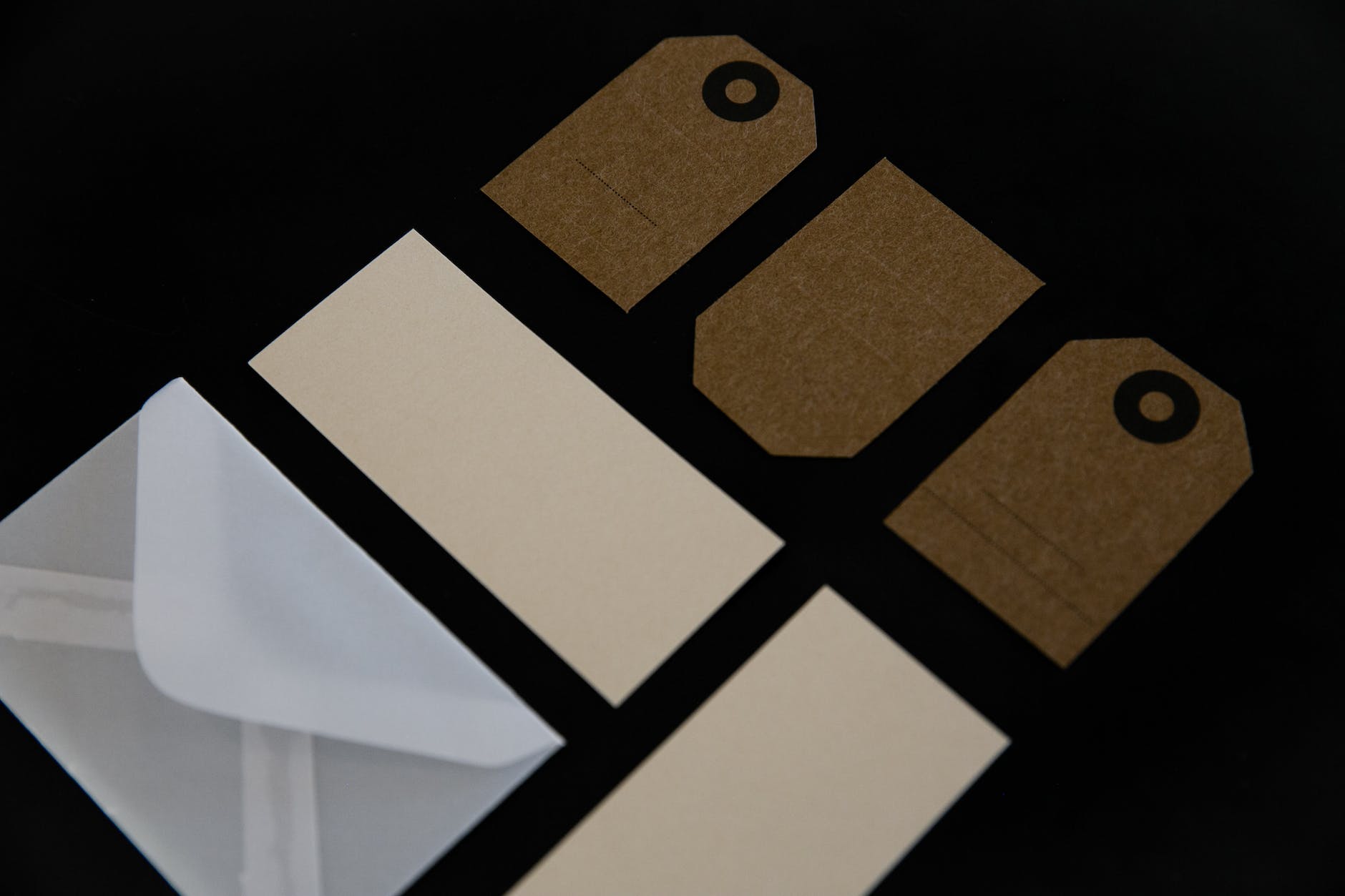 cardboard tags and envelope over black surface