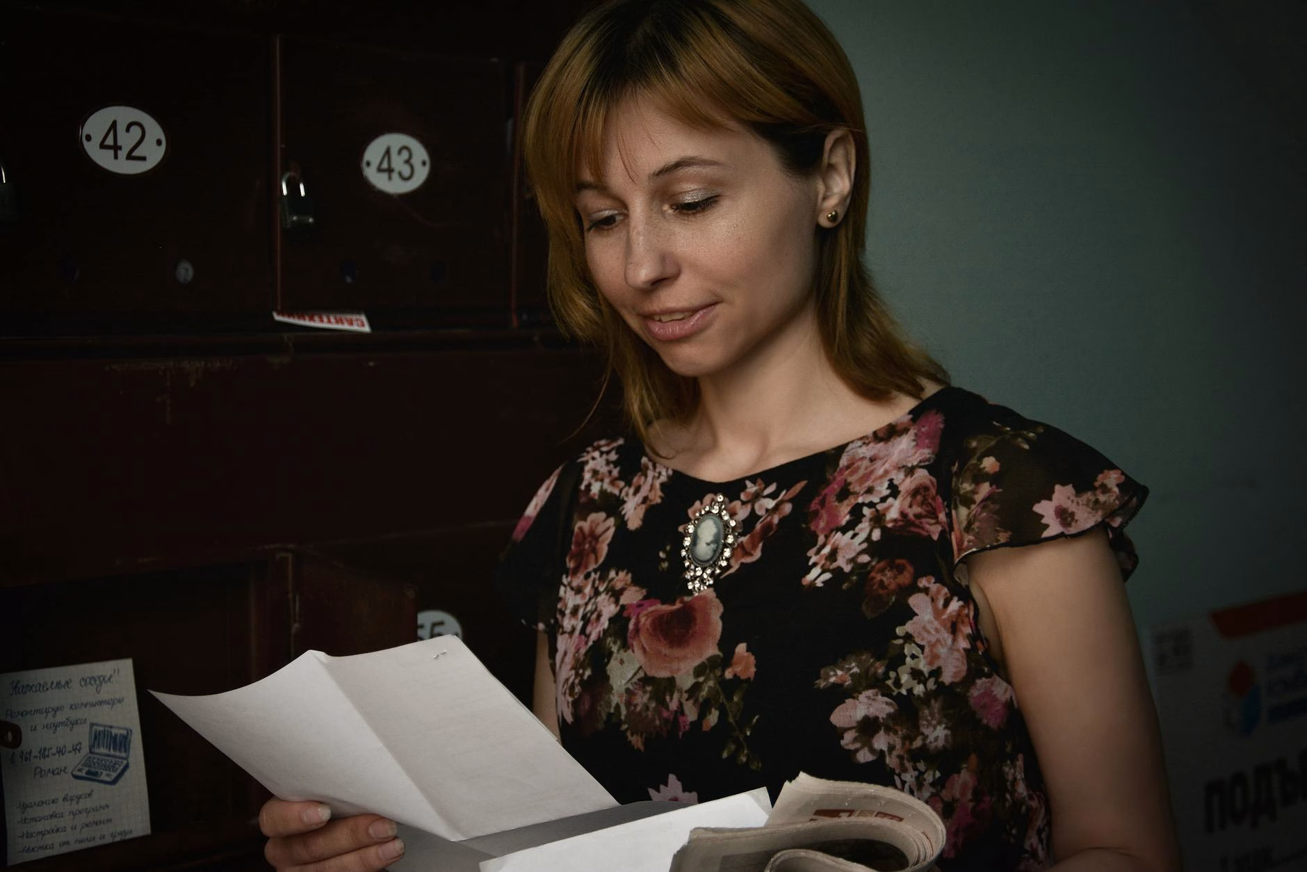 a woman reading the white paper she is holding